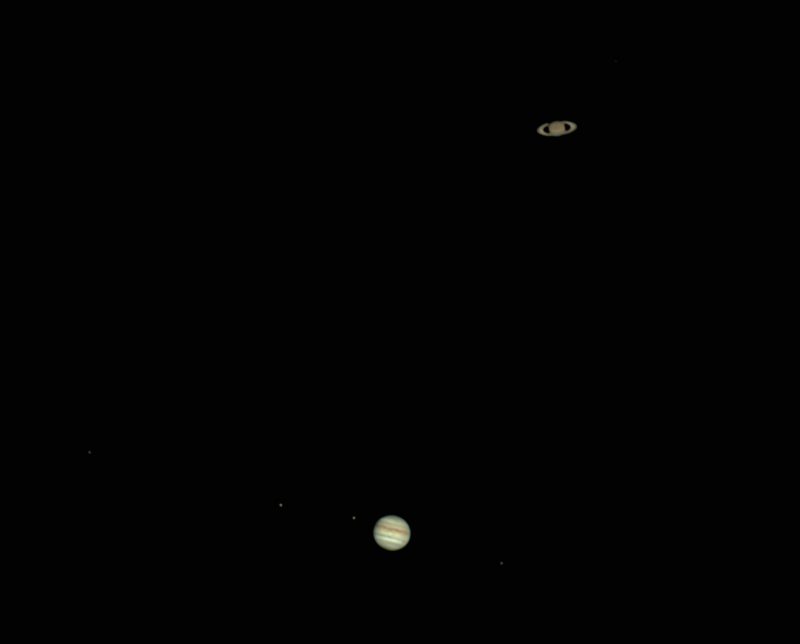 Telescope view of Jupiter and Saturn with rings and stripes clearly visible.