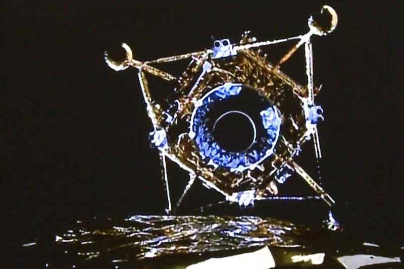 A fragile-looking lunar landing vehicle, seen from its mothership to be descending.