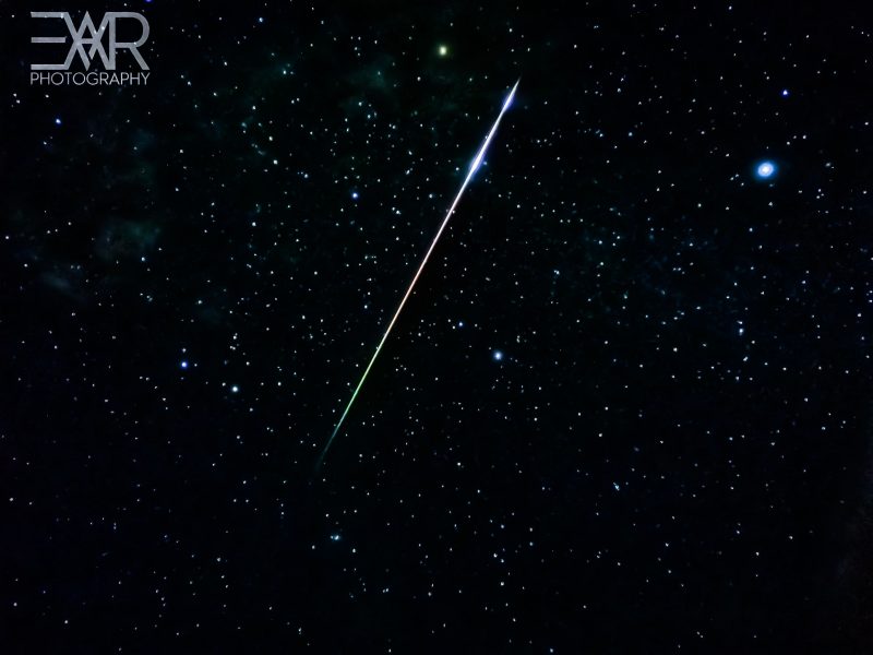 Long, bright, colorful (green, red and blue) meteor.