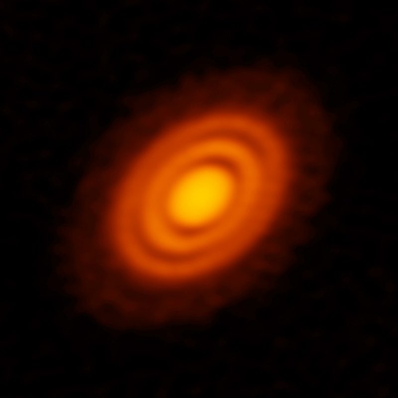 Two fuzzy bright reddish rings around a bright central disk, on black background.