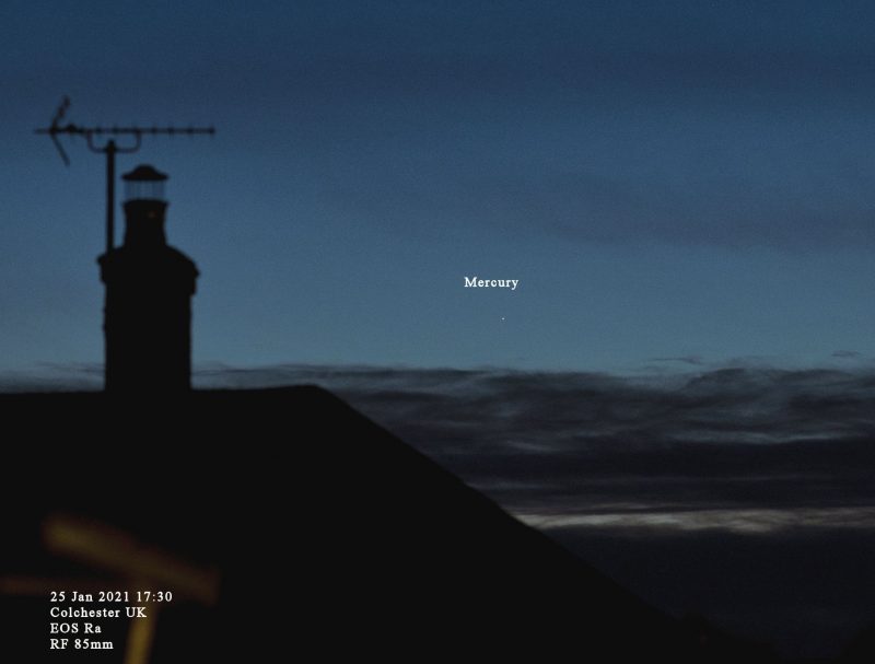 A point of light labeled Mercury in a darkening sky over rooftop with weather vane on chimney.