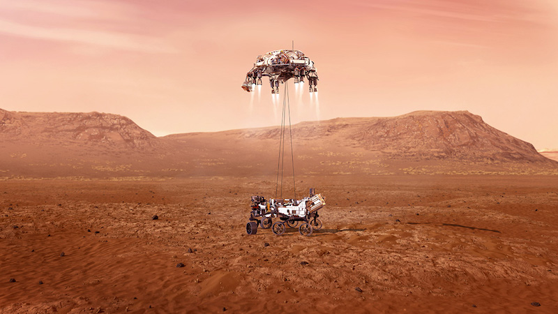 Wheeled machine touching the ground, dangling from a drone-like flyer with 4 rockets, in Mars landscape.