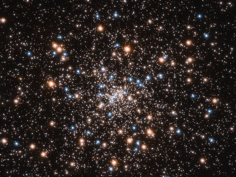 Sphere of hundreds of stars clustered around a center point in a dense star field.