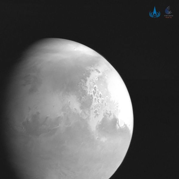 Segment of sphere lower left - Mars in grayscale with features visible.