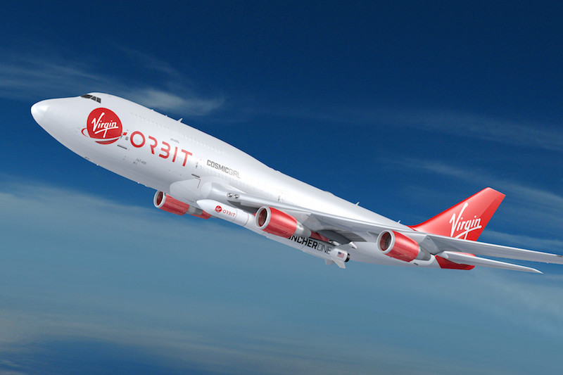 An artist’s illustration of red and white plane displaying the Virgin Orbit logo is drawn carrying the smaller LauncherOne vehicle into a blue sky.