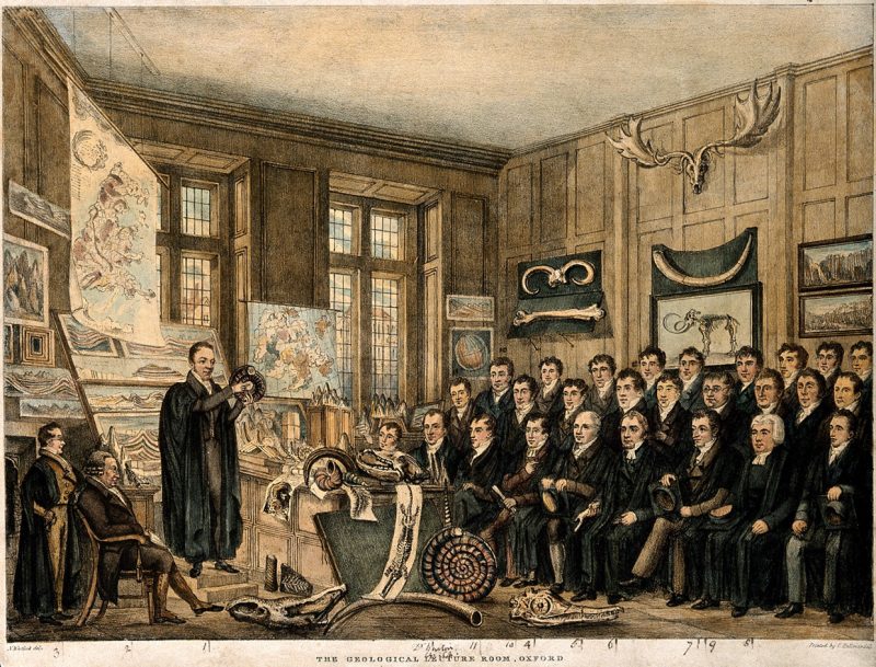 Antique etching of class watching a man in academic robe holding up a rock.