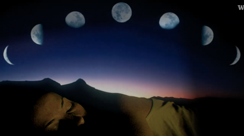 A composite image, showing a mountain ridgeline with the large figure of a human snoozing alongside, and various moon phases arcing overhead.