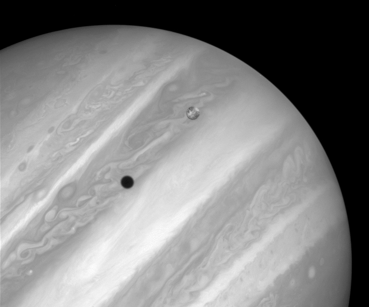Hubble photo of Io and its shadow transiting Jupiter.