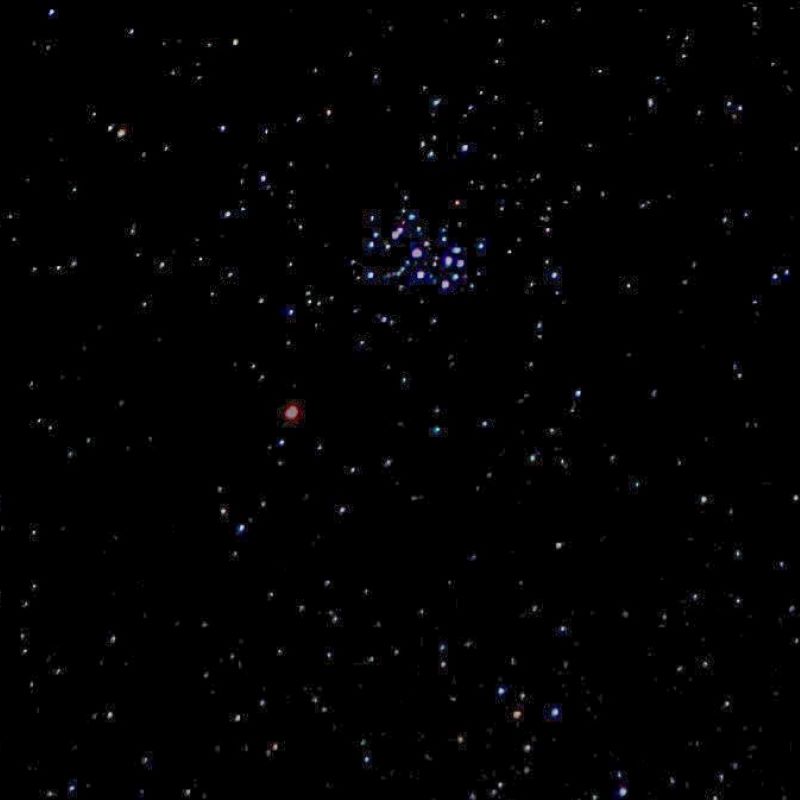 Red dot on black background near cluster of stars.
