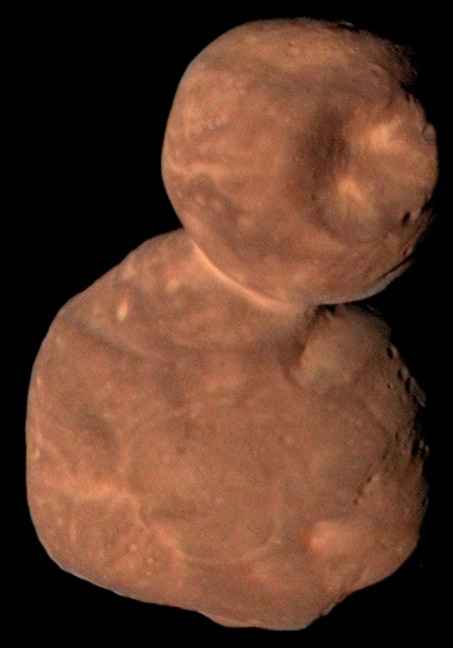 Orangish snowman-shaped rock with two lobes, one much bigger.