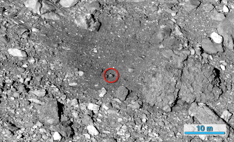 Rocky surface with one rock circled in red, and red X in middle of slightly dark round area.