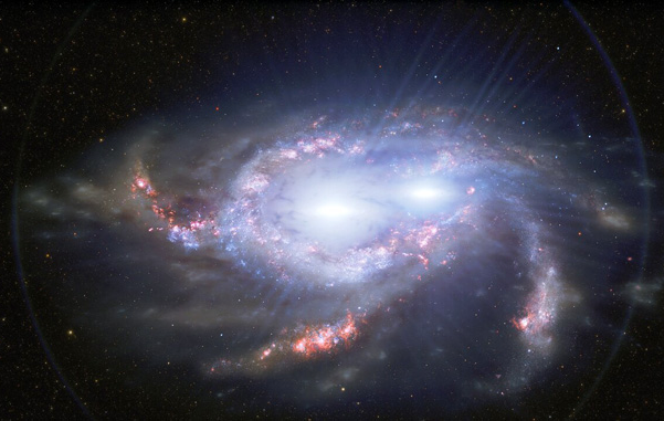 2 galaxies nearly merged, dotted with pink along arms, and centered with 2 brilliant white lights.