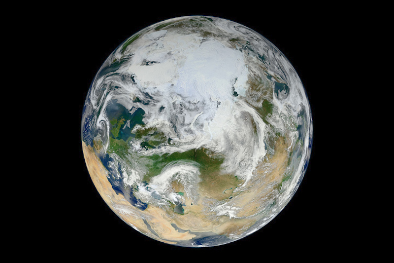 Orbital of north side of planet Earth largely covered in white.
