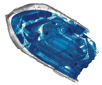 A fragment of blue crystal with concentric lines within it.