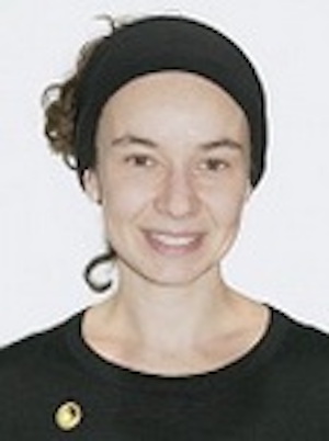 Smiling woman with dark hat and t-shirt.