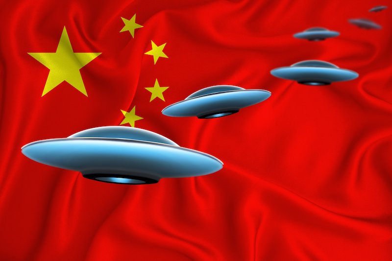 Four flying saucers with Chinese flag in background.
