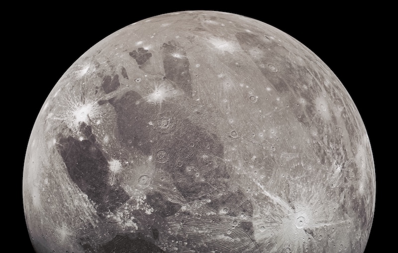 New images of Ganymede, moon-like body with rayed crater and bright and dark patches.