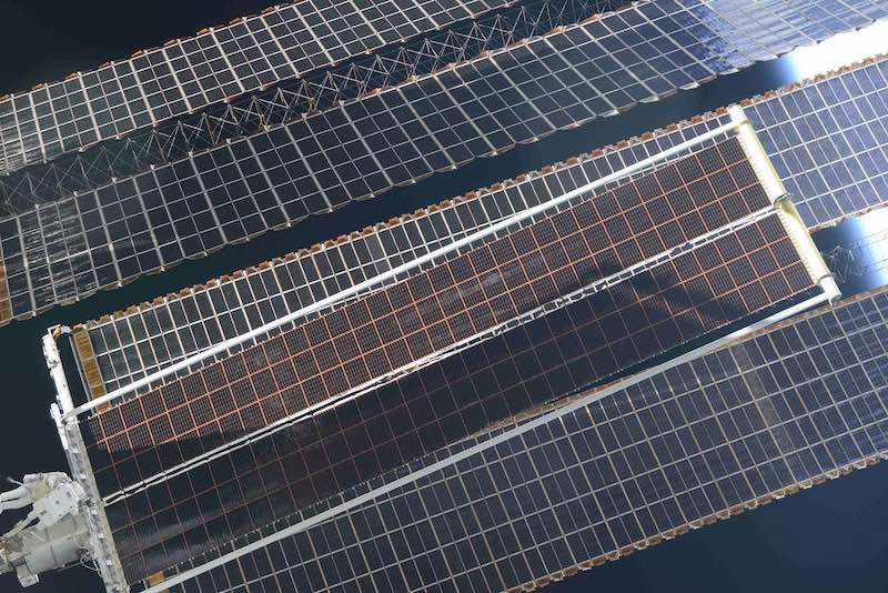 Solar array upgrade of solar panels that look like massive plates with a checkerboard print.