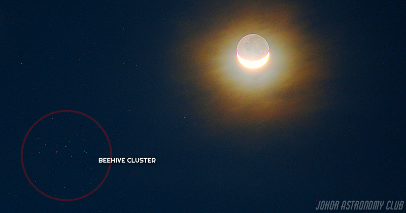 Crescent moon with earthshine near star cluster.