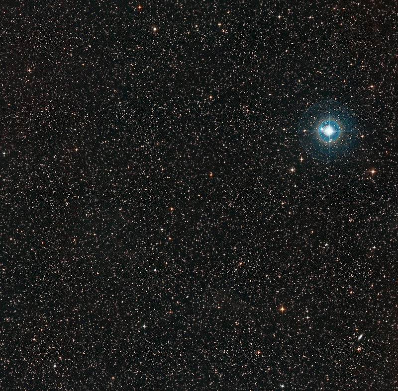 Bright star in upper right, with thousands of more distant stars in background.