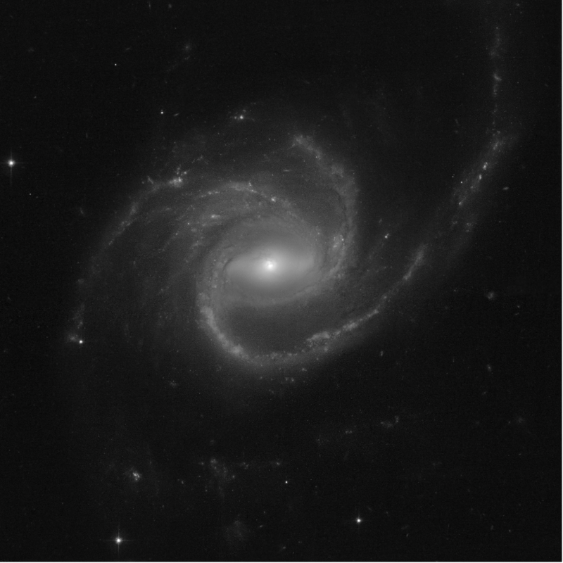 A beautiful spiral galaxy with 3 arms, 1 extended out a large distance.