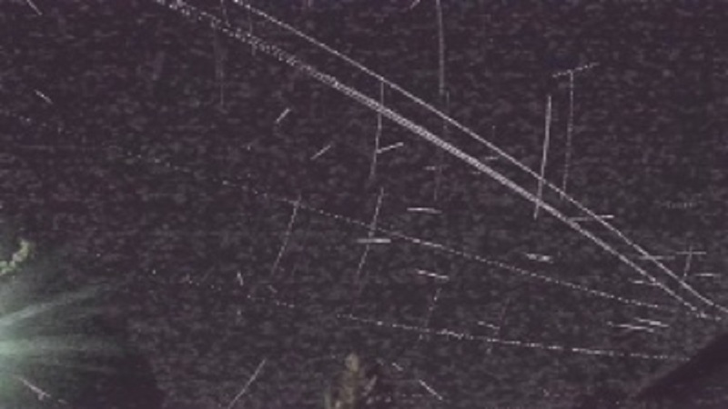 Black background and white streaks appearing to radiate from a point on the left.