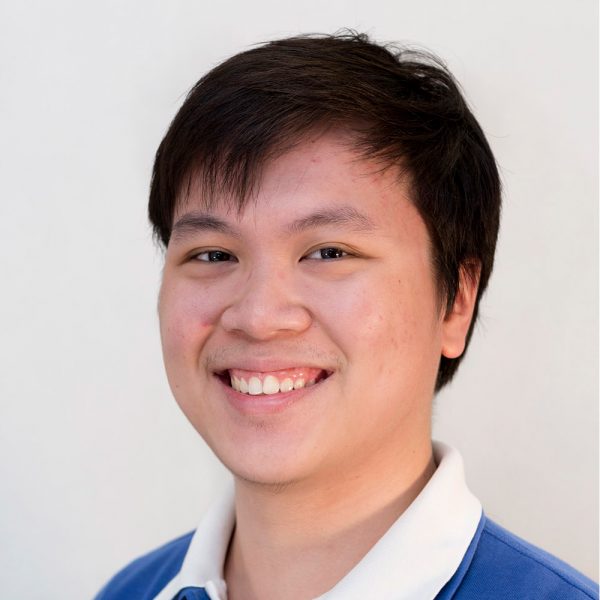 Smiling, young man with dark hair.