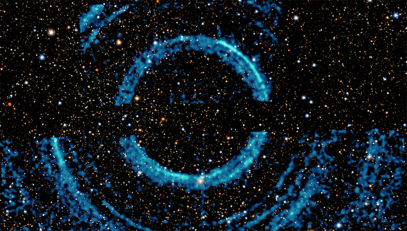 Bluish ring arcs with stars in background.
