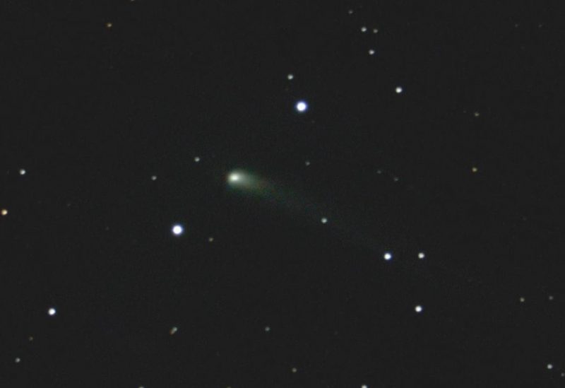 Fuzzy green comet 67P/C-G with a greenish-tinted tail stretching out to the right, among scattered stars.