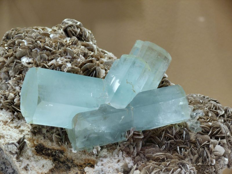 March birthstone: Pale blue hexagonal crystals growing from irregular rock.