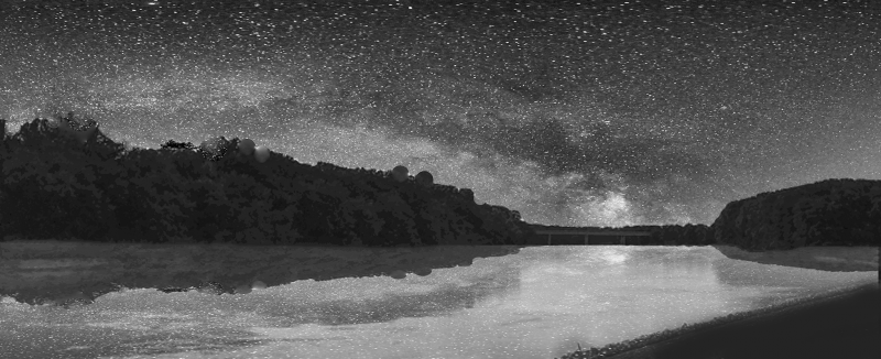 Black and white image of the Milky Way reflected in a large body of water with dark hills behind.