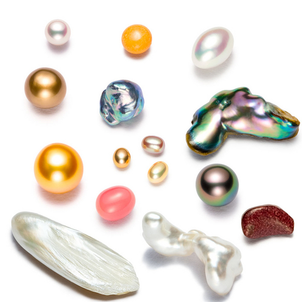 June birthstone: Gleaming round and irregular shapes in different colors on a white background.