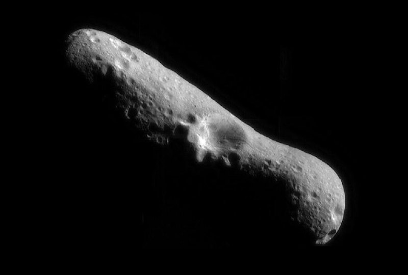 Elongated rocky body with smooth surface and craters.