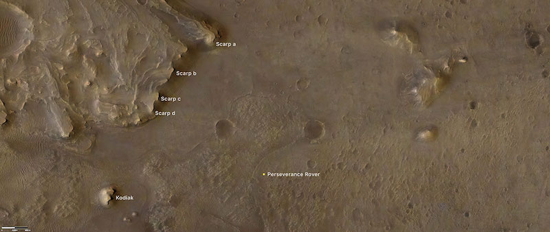 Orbital view of brown land with delta formation and labels.