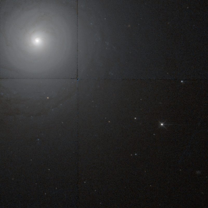 NGC 7213 is a washed out round galaxy in upper left with bright center and fading light.