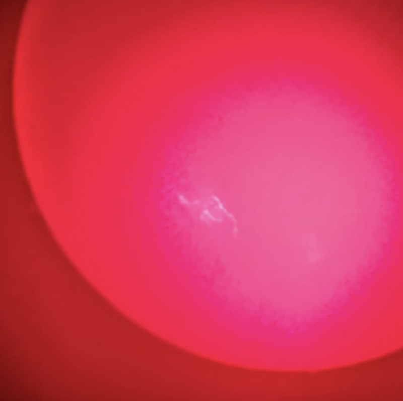 Aurora alert: A red-colored sun with a few short, wiggly white lines in a bunch on it.