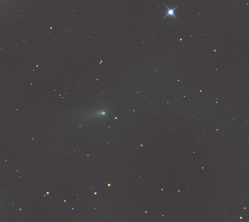 Small fuzzy elongated green dot with long barely visible fuzzy tail in star field.