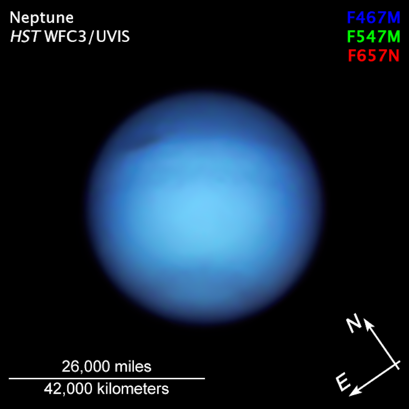 Planet faintly banded in varying blue colors, with dark oval spot. Text annotations.