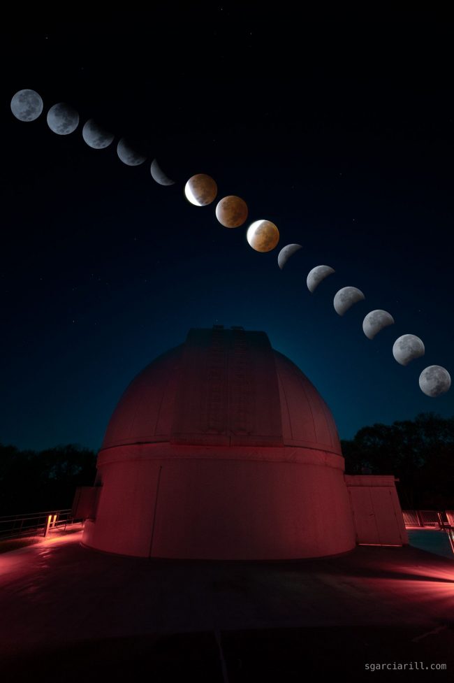 Line of moons from upper left to lower right showing the phases of the eclipse above an observatory dome.