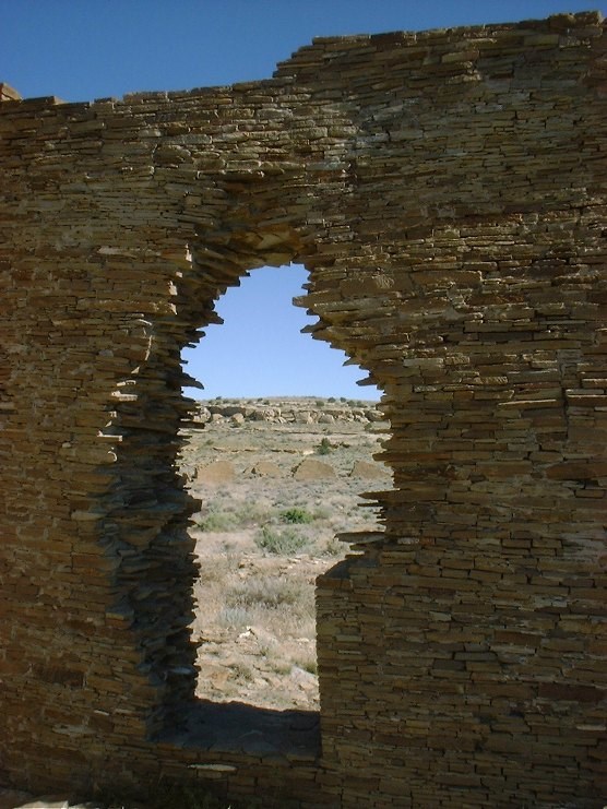 A keyhole-shaped doorway in a finely built rock wall.
