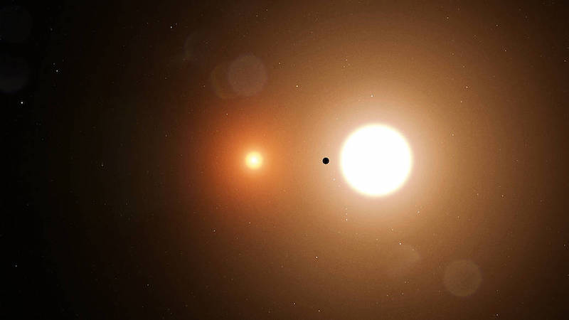 Two bright suns with smaller planet between them.