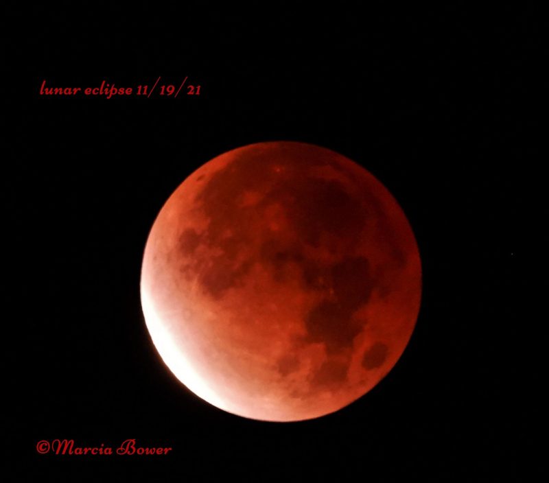 A reddish 97%-eclipsed moon.