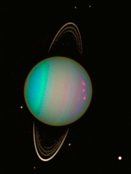 Planet in space with thin ring and several moons. Planet has colorful bands and spots.