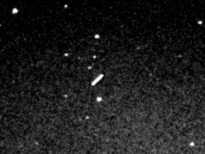 White streak of light at center denotes asteroid in dark field.