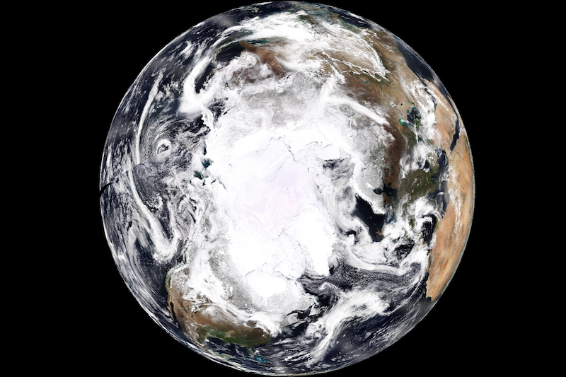 View of Earth from above covered in white from ice and clouds.