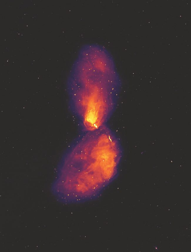 Black hole eruption: Two long, oval lobes of gas opposite each other, orange at center with purple at edges.