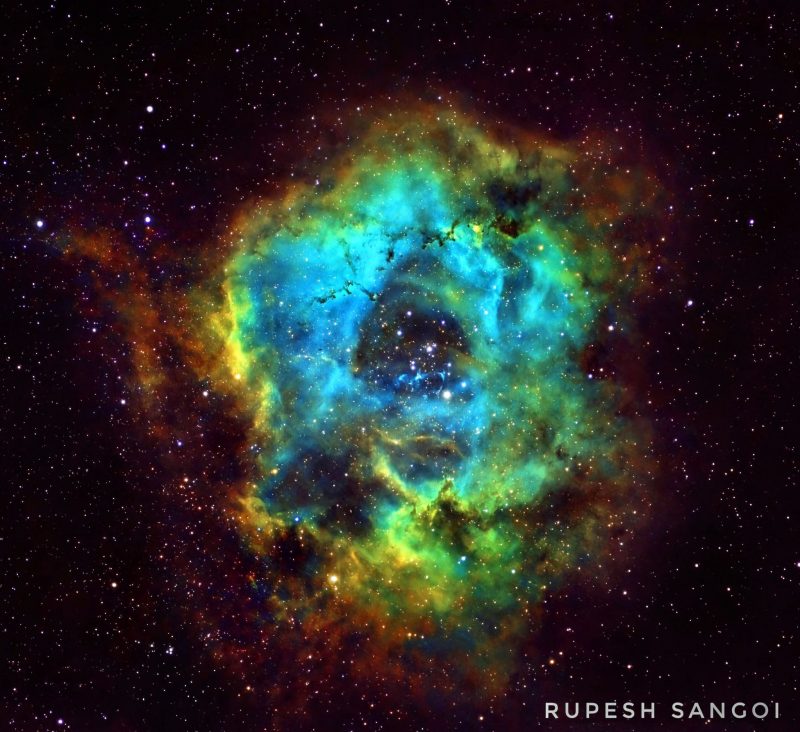 Rainbow-colored circular dust cloud in the deep sky.