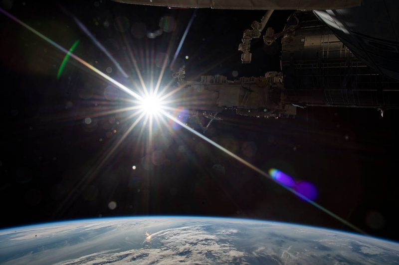 December solstice and January perihelion: Sun with spikes as seen from the International Space Station with Earth below.