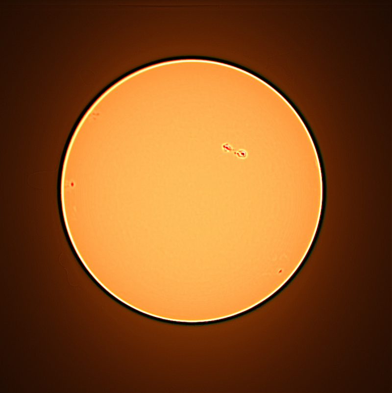 Round yellow sun with sunspots outlined in lighter color.