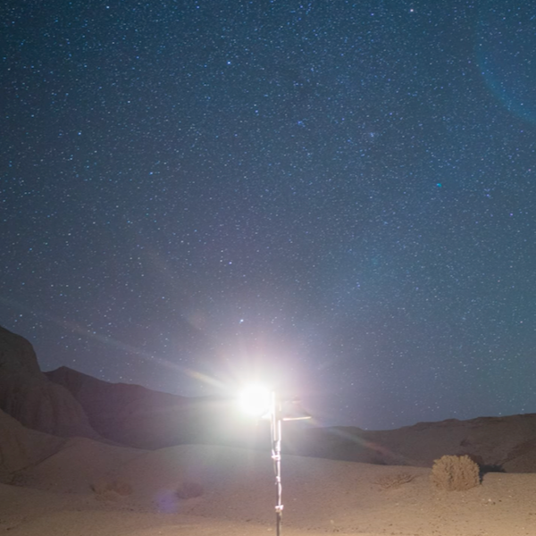 Shielded versus unshielded lighting: Light fixtures on pole in desert. The unshielded one is very bright! The other barely visible.